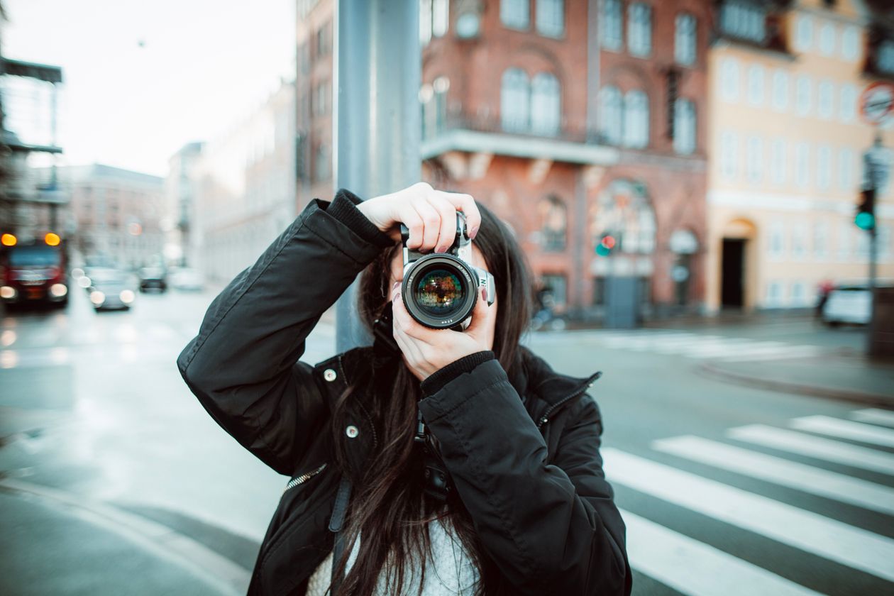 Woman photographer on city street